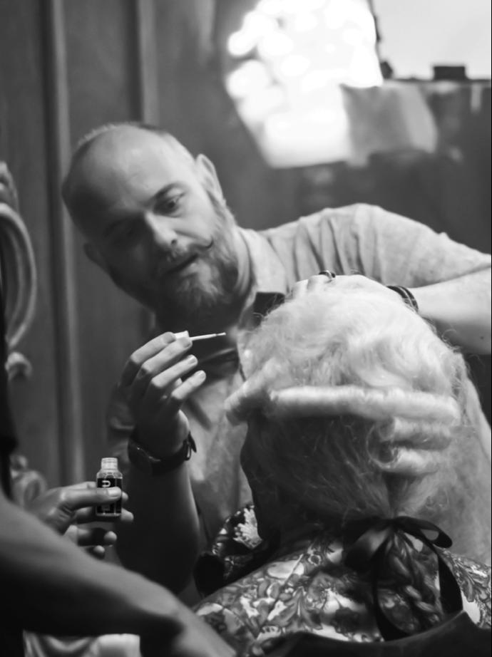 Orlando Bassi founder of GluHU Silicon Based Lace Adhesive System applicating the gluhu adhesive on actor