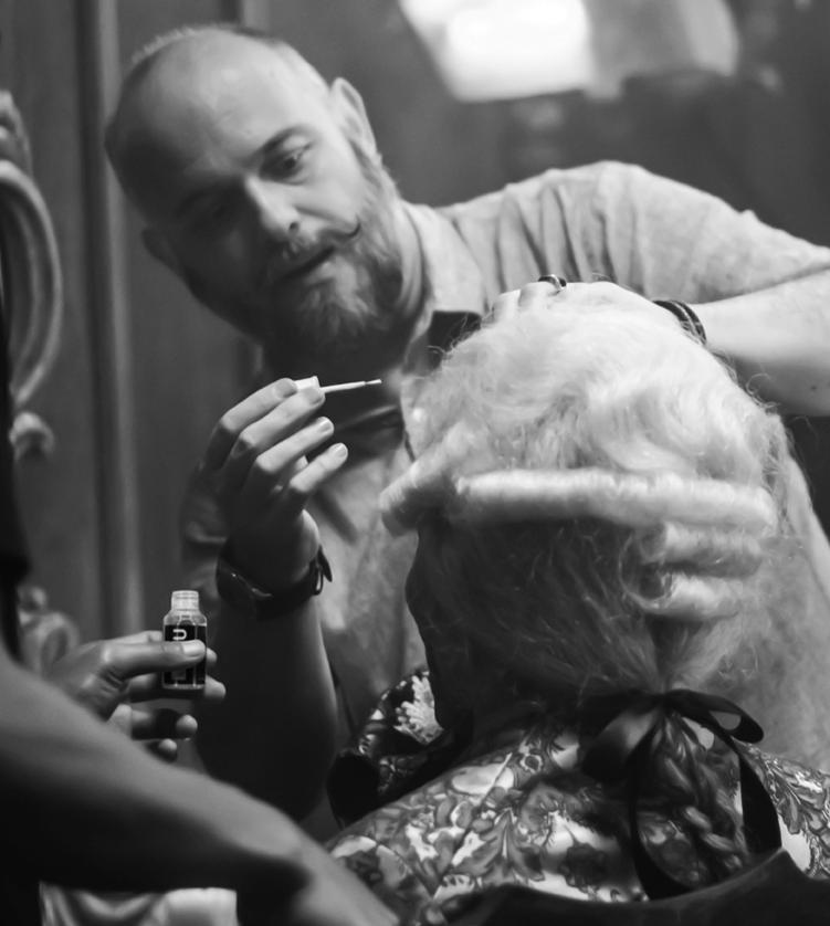 Orlando Bassi founder of GluHU Silicon Based Lace Adhesive System applicating the gluhu adhesive on actor